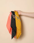Leto Collection dotted and floral bandana with colorful patterns, made of lightweight fabric, styled as a versatile accessory.