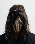 Black dotted and floral bandana by Leto Collection, showcasing a stylish fabric with a vibrant floral pattern and dotted design.