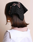 Black dotted and floral bandana from Leto Collection, featuring vibrant patterns and lightweight fabric.