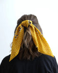 Yellow dotted and floral bandana from Leto Collection, featuring vibrant patterns and soft fabric for stylish accessory wear.