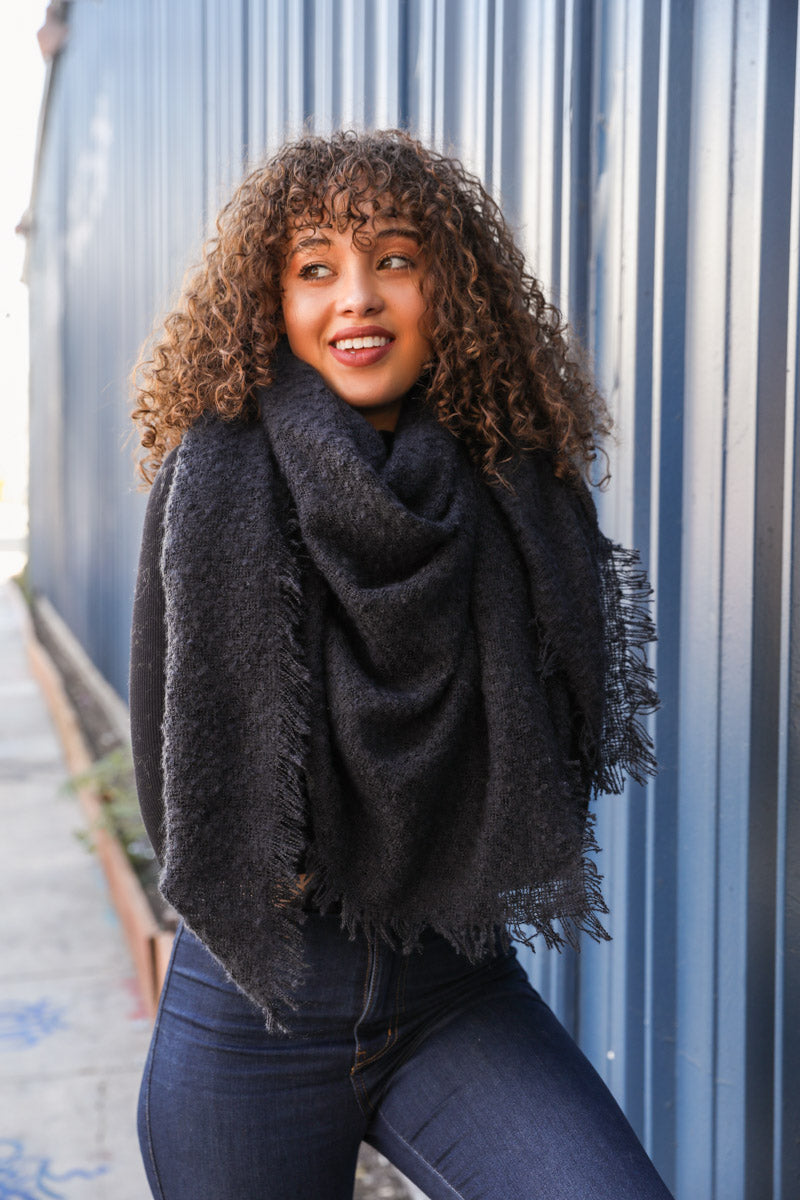 Black Leto Collection mohair square blanket scarf displayed folded with soft, textured fabric and subtle fringed edges.