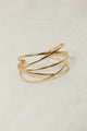 Adjustable metallic cuff gold armlet with a polished finish.