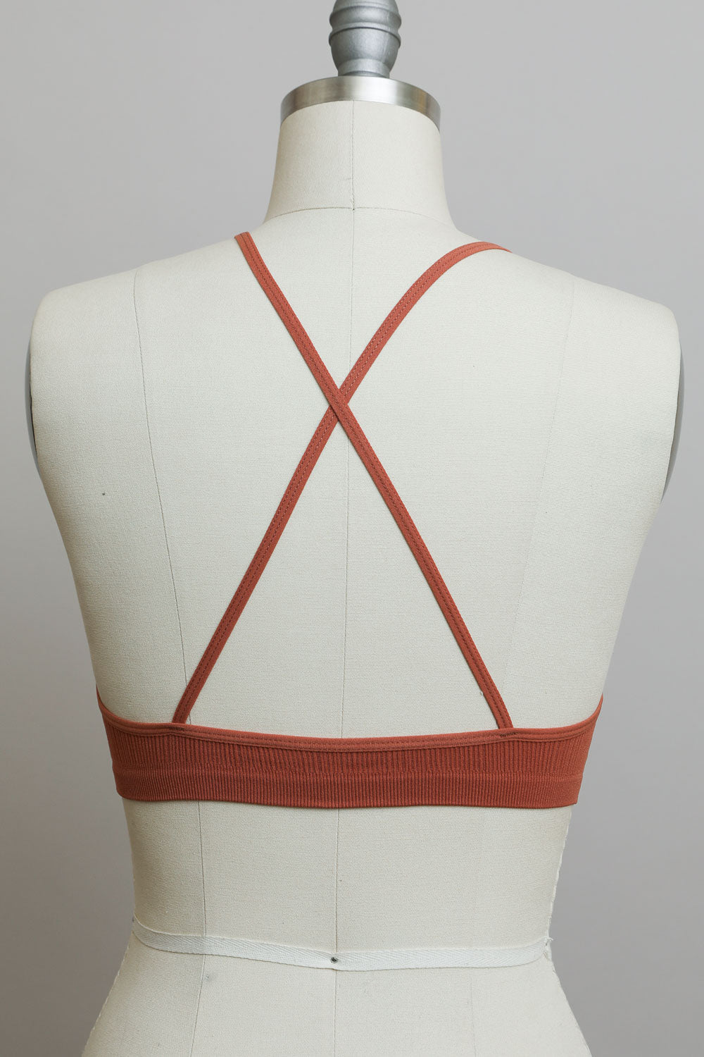 Breathable high neck crochet rust bralette with cross-back straps.