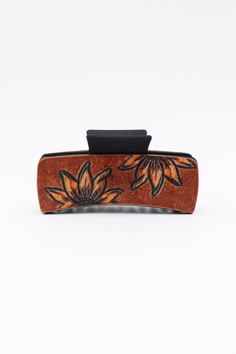 Dainty sunflower hair claw with floral design and strong clam grip, perfect for styling.