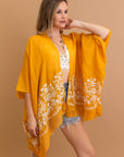 Elegant and lightweight Enchanted Mustard Bloom kimono for versatile style.