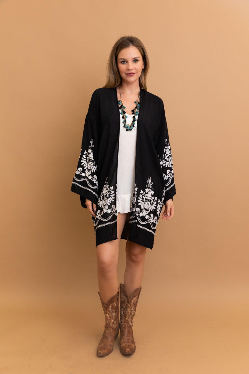 Floral black kimono wrap made from breathable viscose polyester blend.