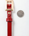 Gold buckle thin red belt for chic and elegant looks.