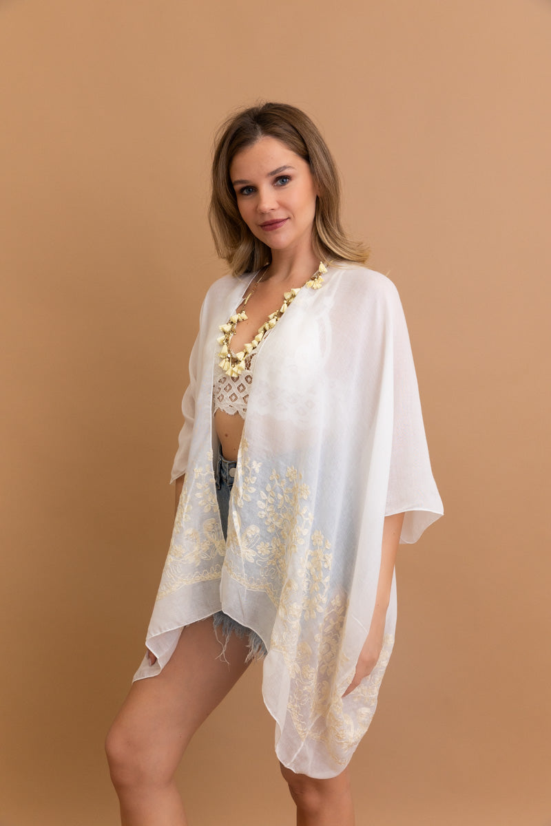 Sophisticated embroidered white kimono with detailed floral pattern.