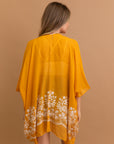 Stylish mustard floral embroidered kimono for layering over any outfit.
