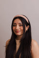 Vegan leather patterned blush headband with polyester design.