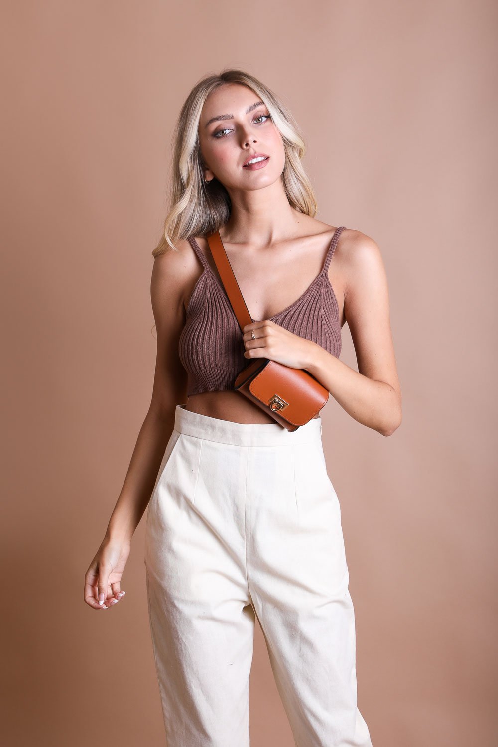 Cognac vegan leather mini belt bag, stylish and versatile.