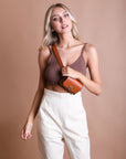 Cognac vegan leather mini belt bag, stylish and versatile.