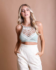 Crochet lace high neck sage bralette with halter style and cross-back straps.