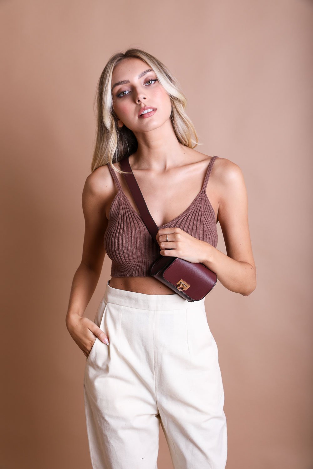 Elegant burgundy mini waist belt bag made with faux leather.