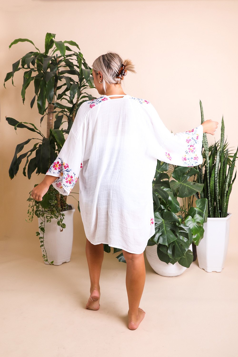 Elegant floral embroidered white kimono with sophisticated details.