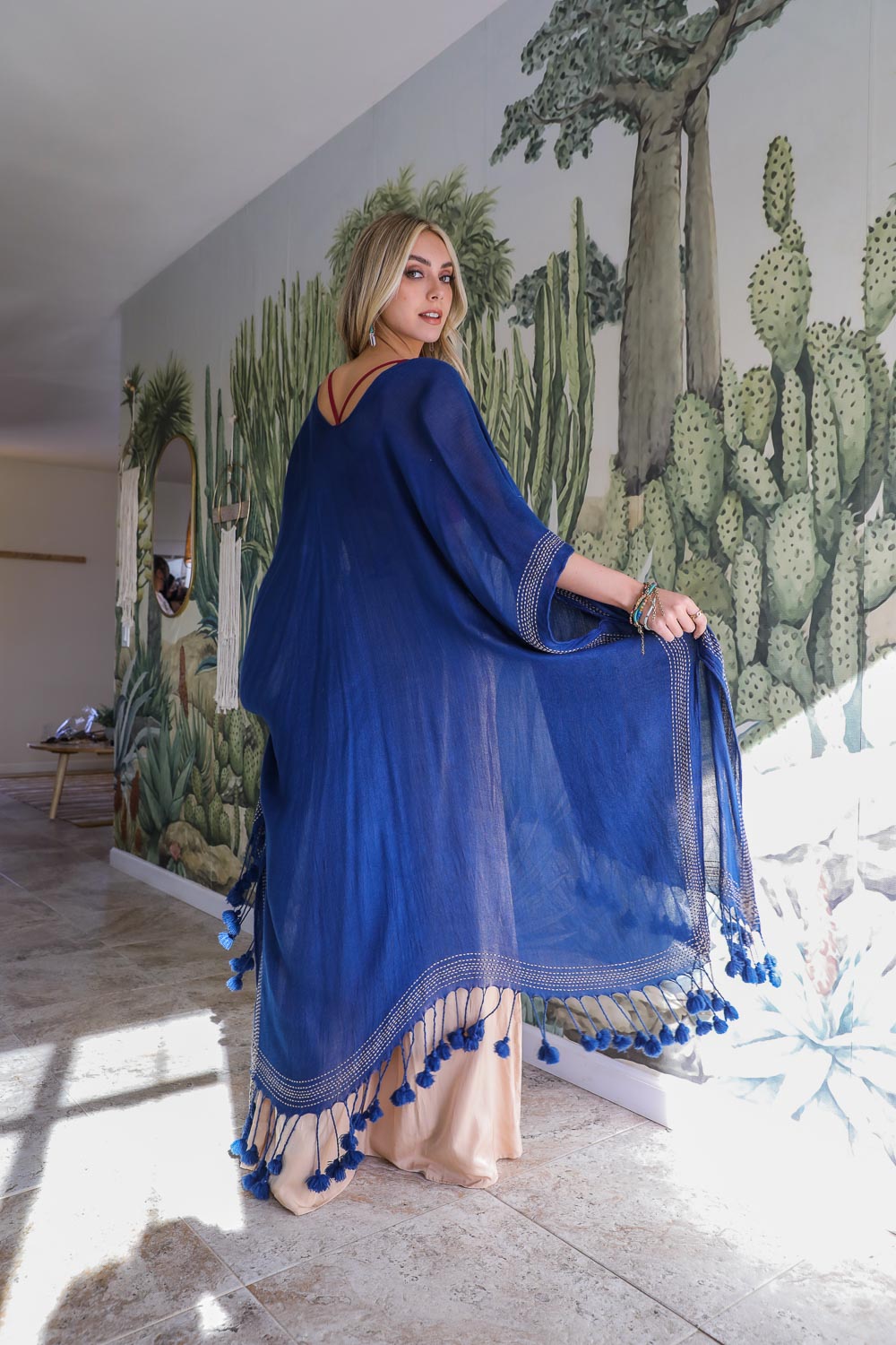 Elegant longline navy kimono with tassel fringe details, designed for effortless style.