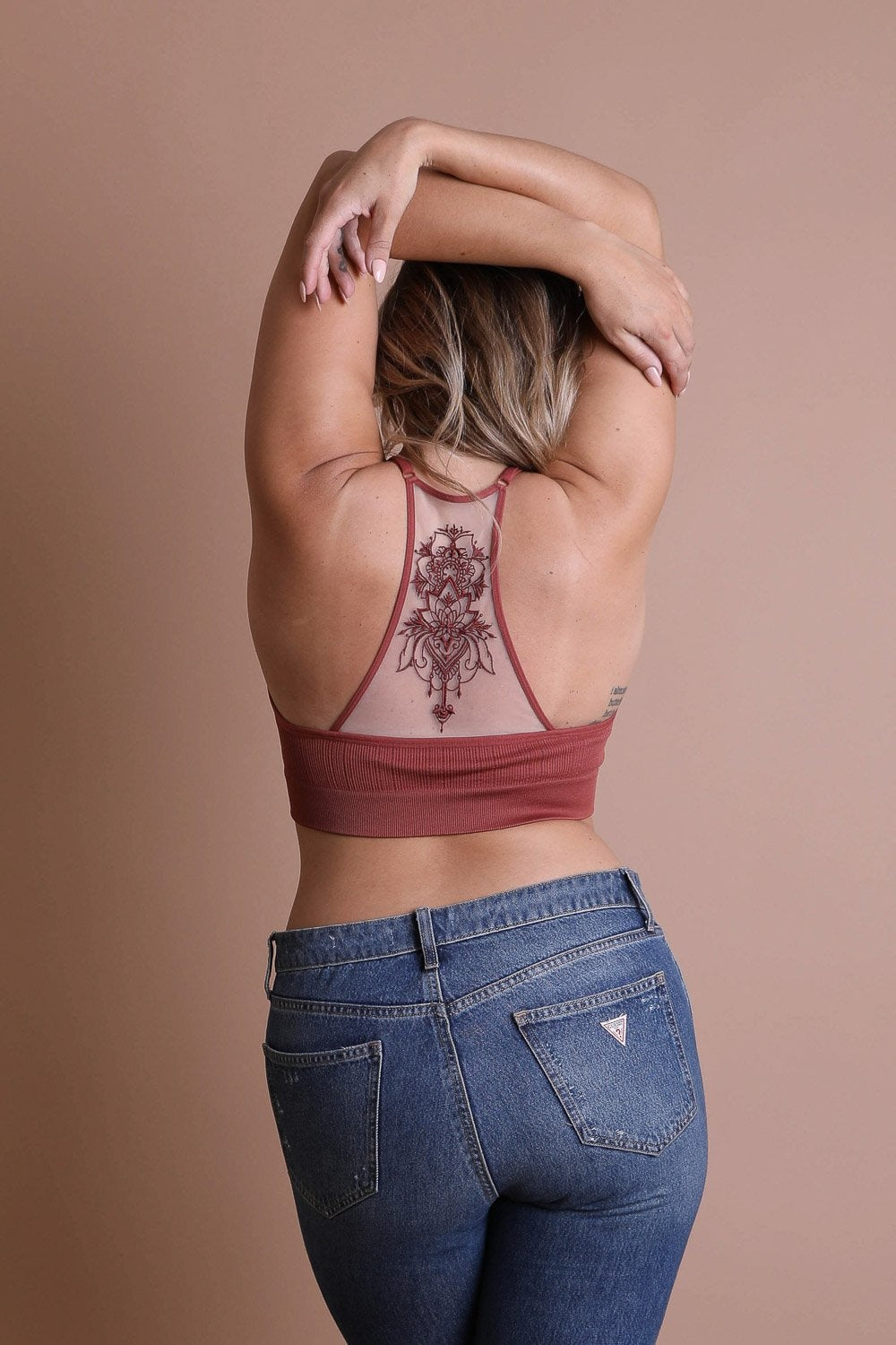 Feminine tattoo back rust bralette with mesh racerback style.