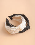 Floral embroidery knot headband made from lightweight polyester.