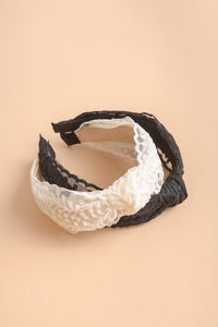 Floral embroidery knot headband made from lightweight polyester.