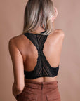 Lightweight black lace racerback bralette with seamless and stylish design.