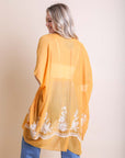 Lightweight mustard floral kimono featuring intricate embroidery details.