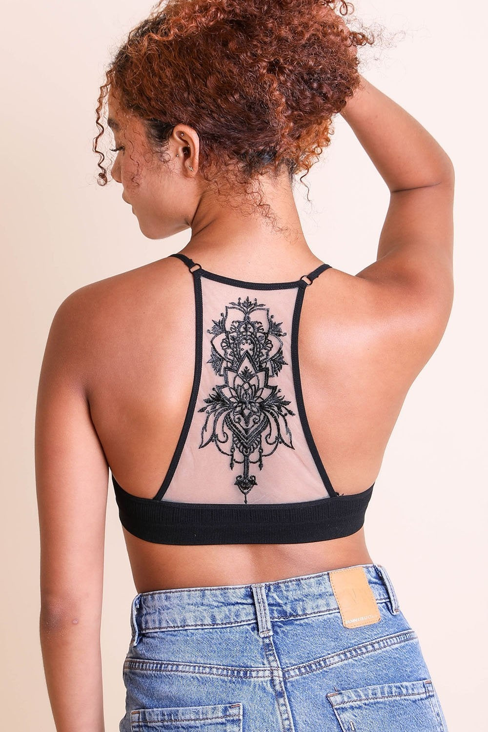 Lightweight tattoo back black bralette with seamless design.