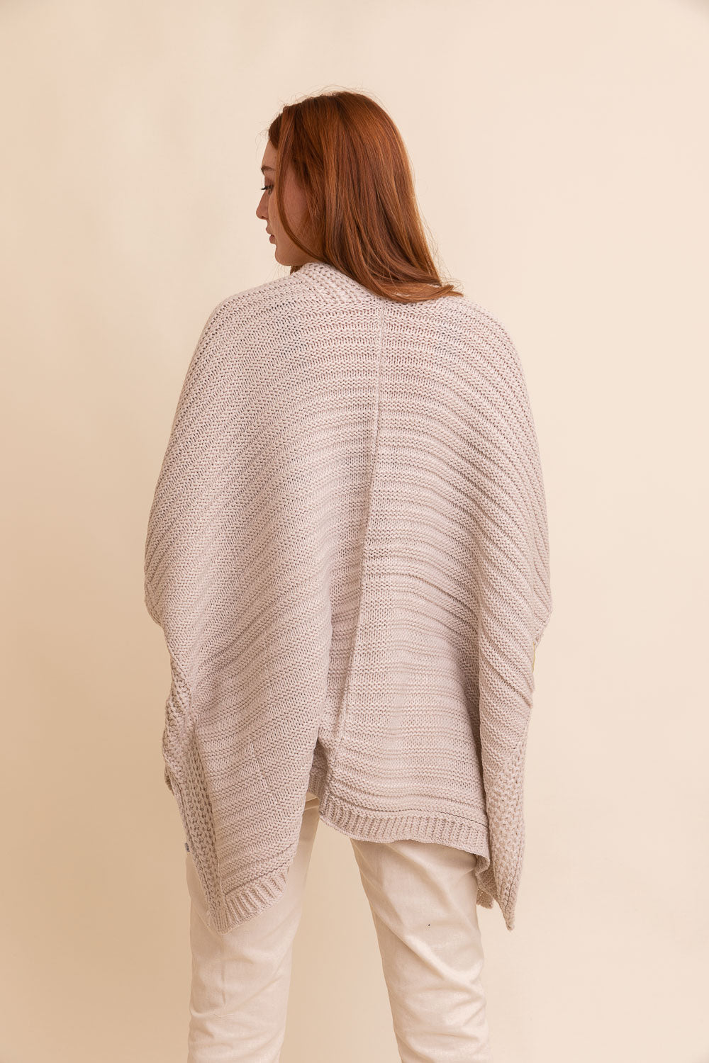 Ribbed knit oatmeal cape, lightweight and cozy layer for sophisticated, elegant looks.