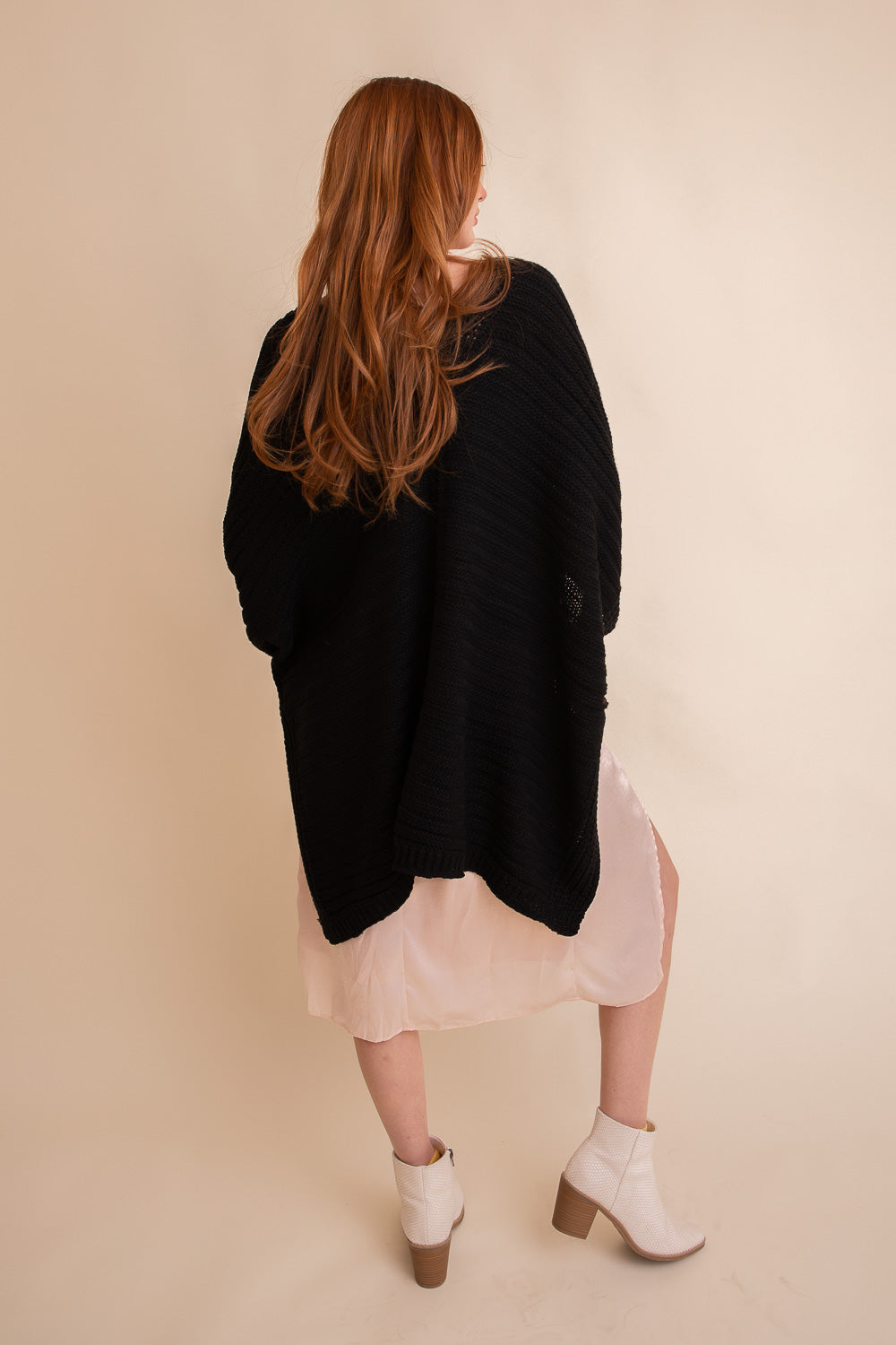 Soft ribbed knit black ruana, a comfortable layering piece for cool days.