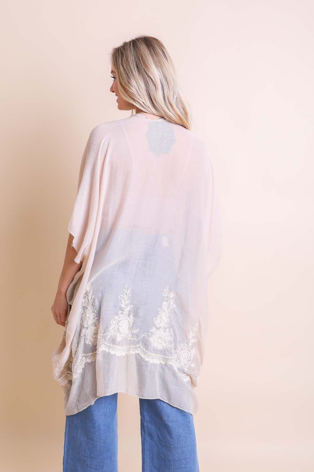 Sophisticated embroidered white kimono with detailed floral stitch design.