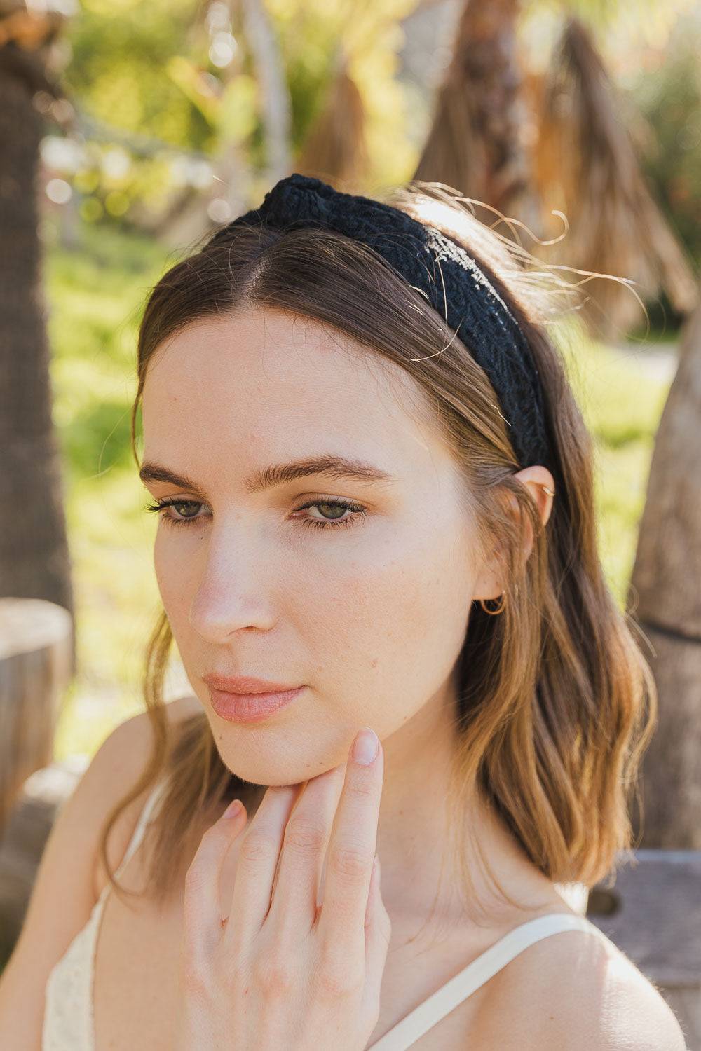 Stylish embroidered floral knot black hairband with elegant design.