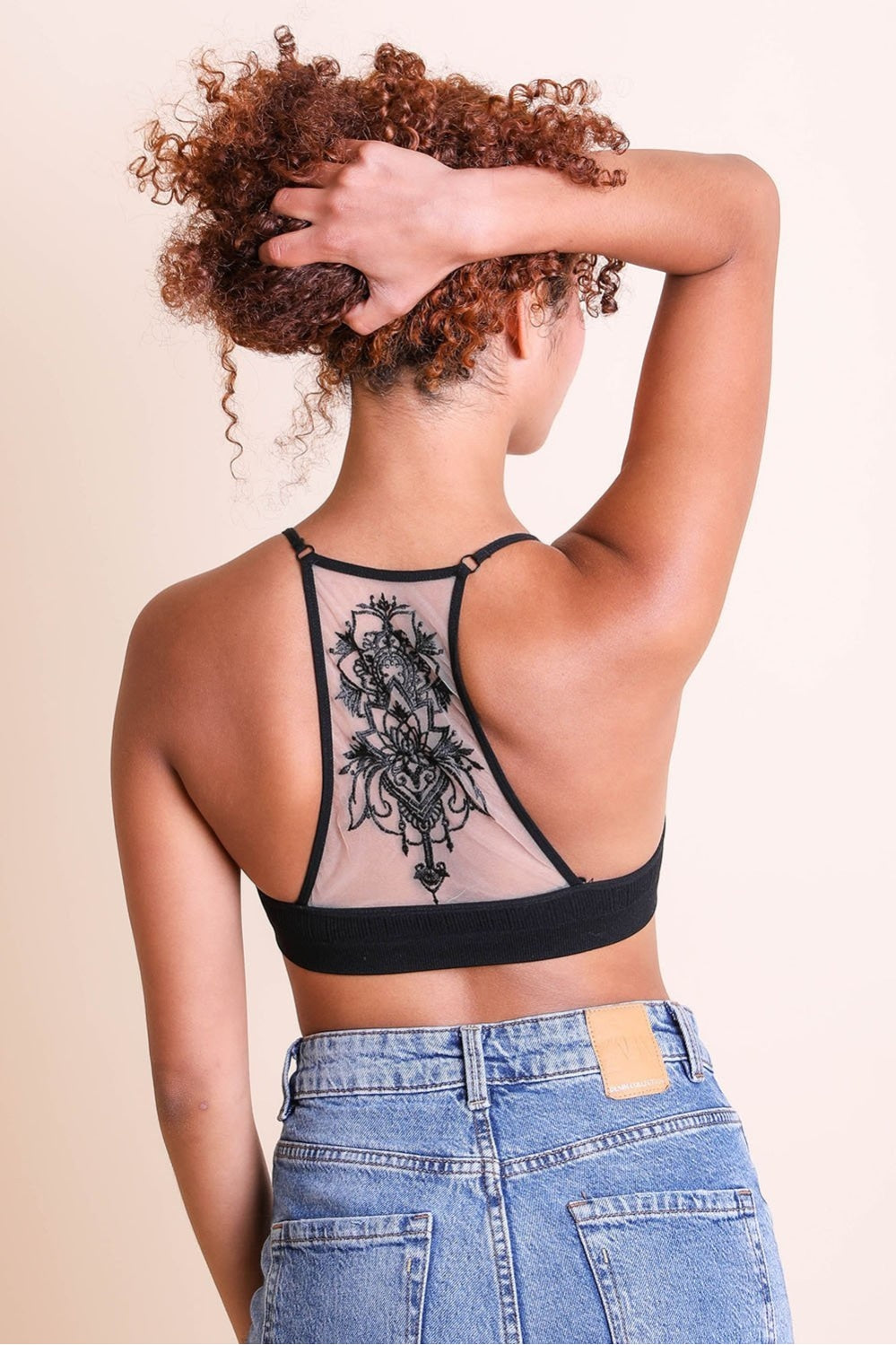 Stylish tattoo back black bralette with mesh racerback style.