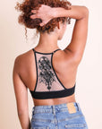 Stylish tattoo back black bralette with mesh racerback style.