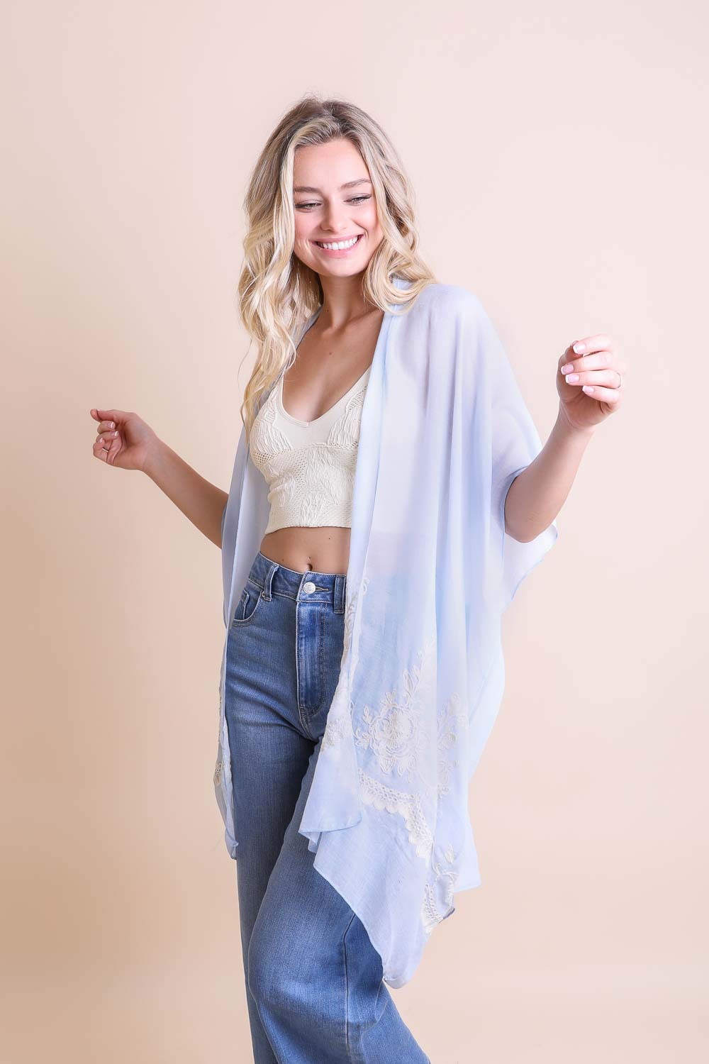 Versatile floral embroidered blue kimono made with soft and durable fabric.